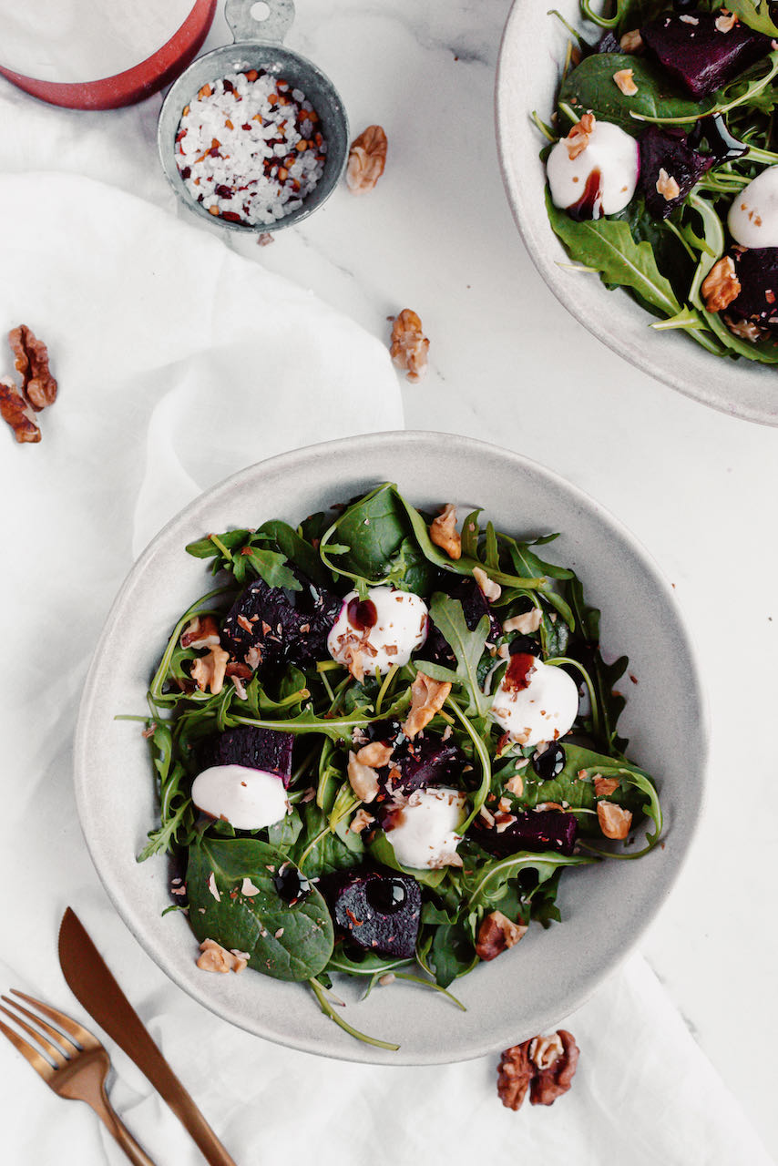 Roasted beetroot and greens salad flatlay focus on the plate below