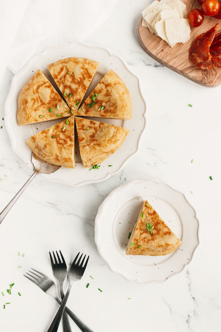 Spanish tortilla flatlay photo sliced and piece served