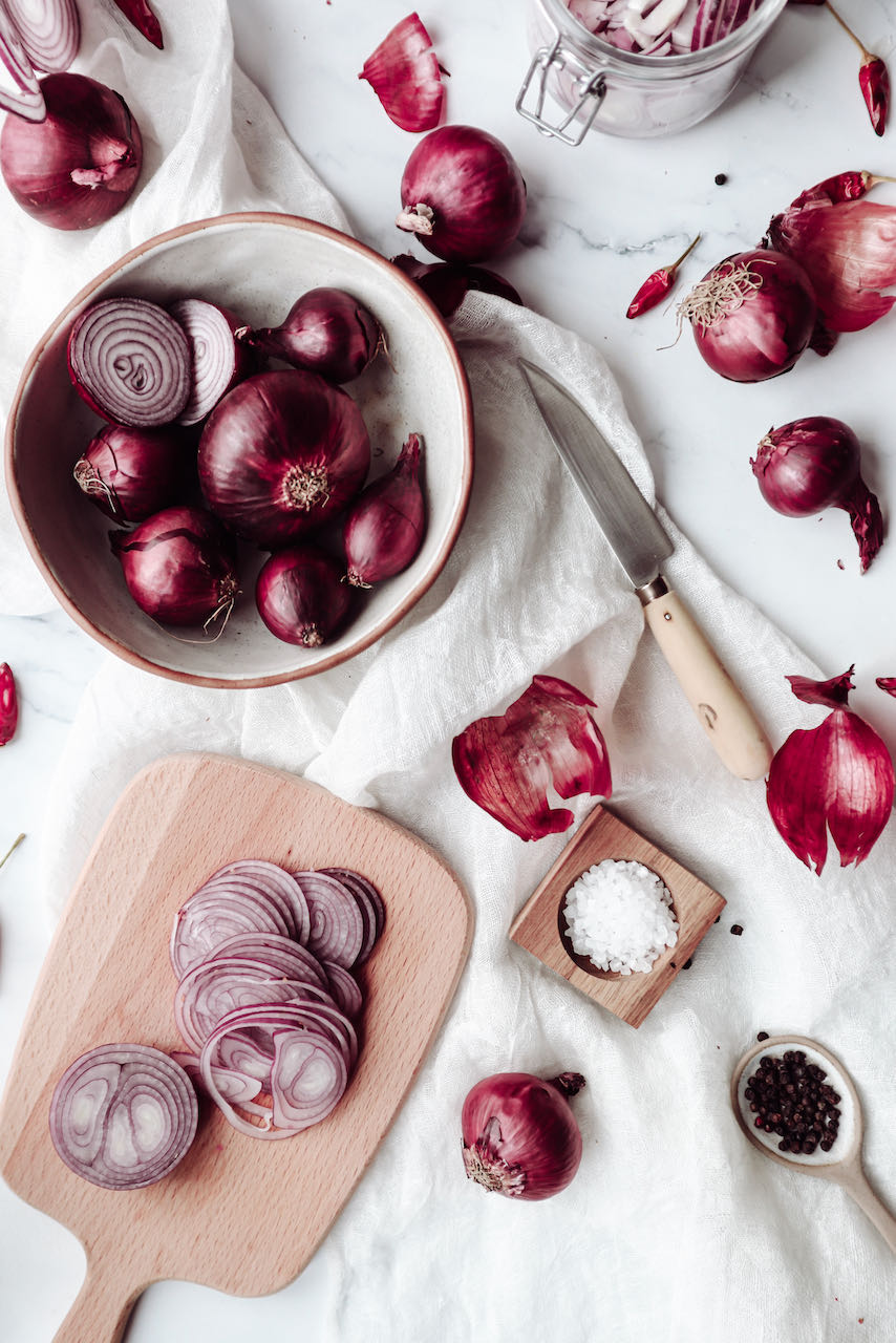 Sliced onions on the board for pickled red onions